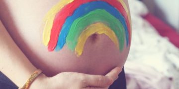 Maternity/Pregnancy shot showing a colorful painted baby bump. Maternity/Pregnancy shot showing a colorful painted baby bump.