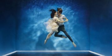 A couple dancing under water in a intimate moment A couple dancing under water in a intimate moment