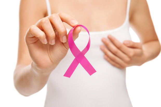 Woman with a pink breast cancer awareness ribbon